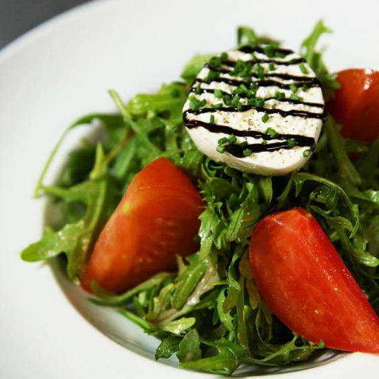 Bistro de la Gare (courtesy) - Heirloom tomatoes on arugula with burrata cheese